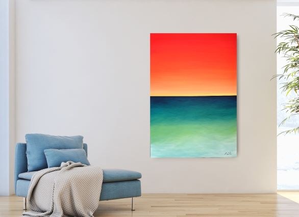 Sunset seascape in red, orange and turquoise above a light blue sofa